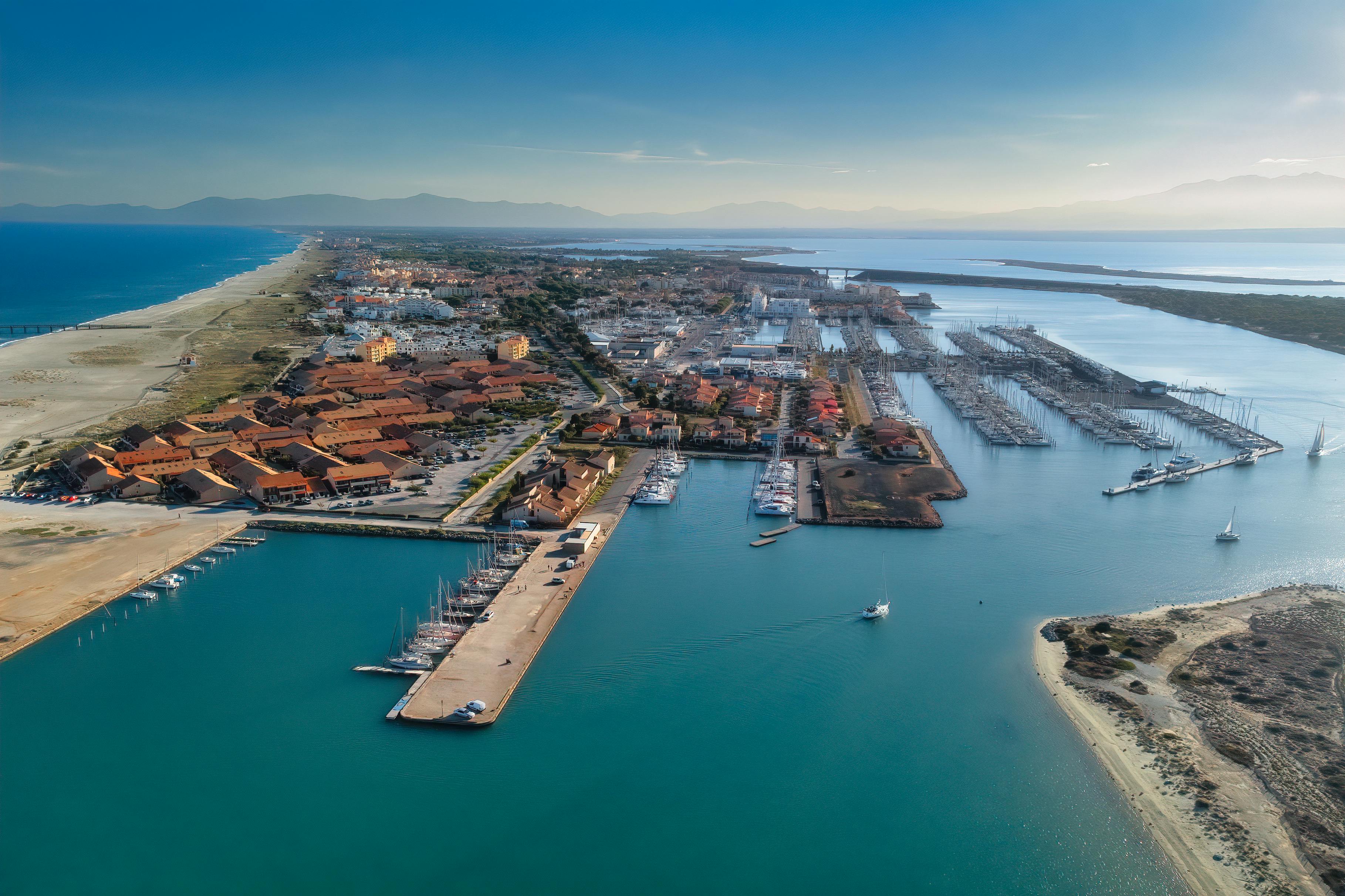 Stunning aerial view of Leucate Marina, France, showcasing azure waters and the harbor's layout.