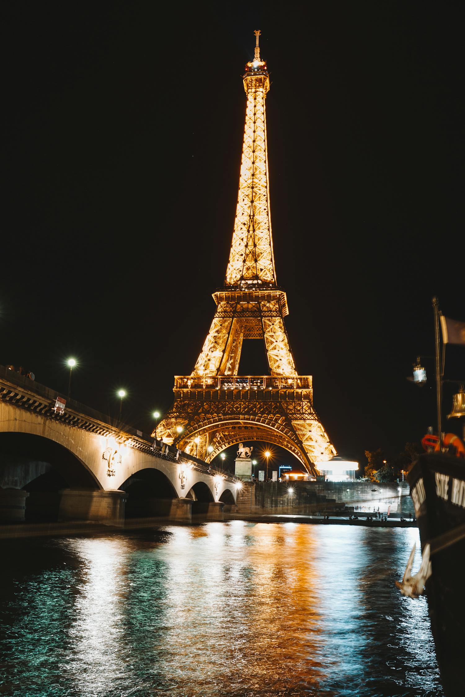 Low Angle Shot Of The Eiffel Tower With Illuminated Light At Night