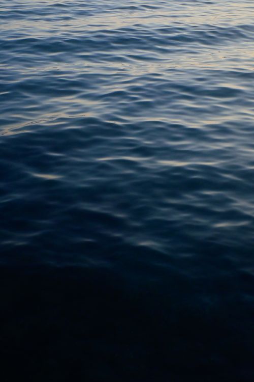 Free Capture of gentle waves at sunset in Assos, Türkiye, showcasing serene, clear blue waters. Stock Photo