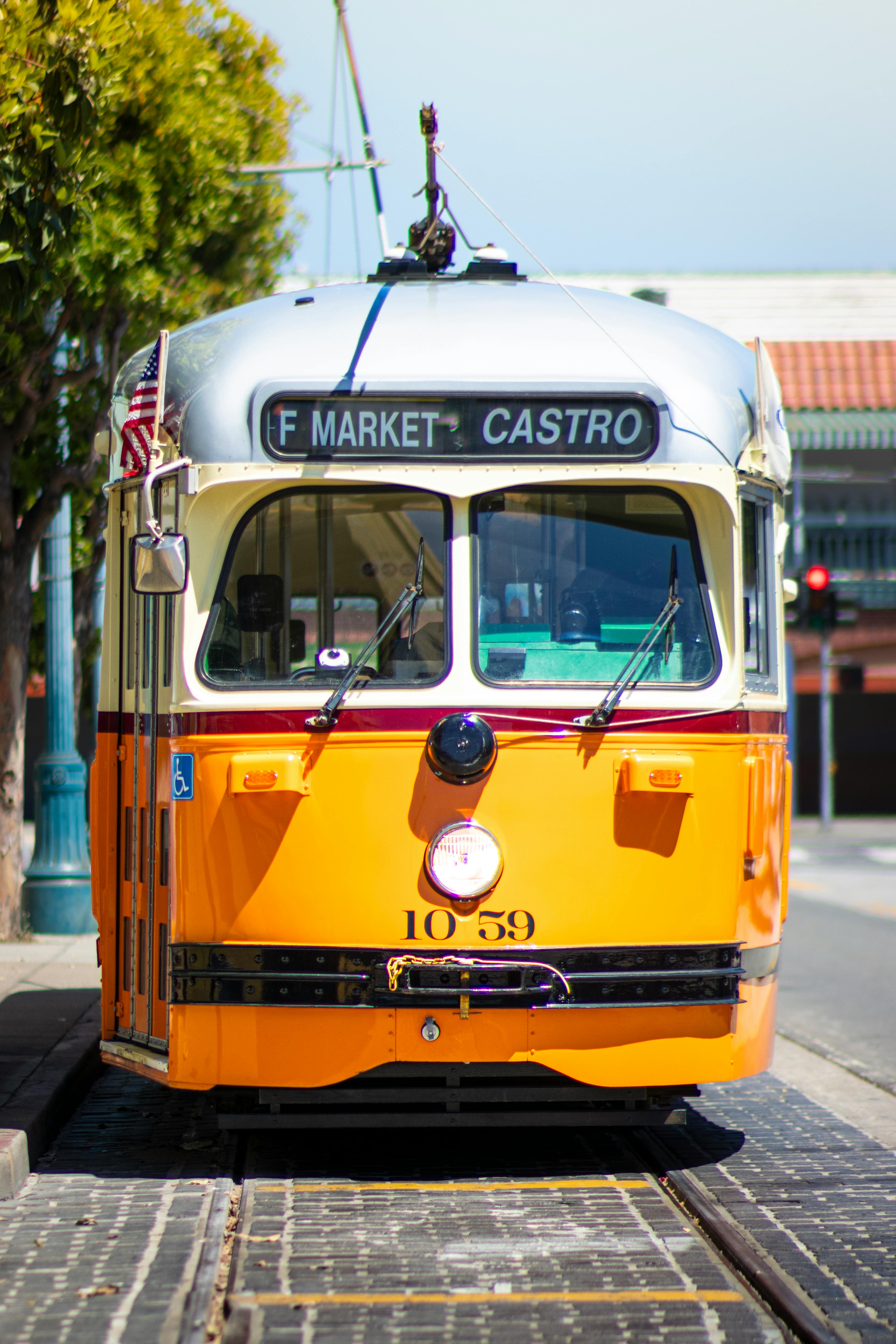 Free A classic yellow streetcar traveling through the vibrant streets of San Francisco, California. Stock Photo