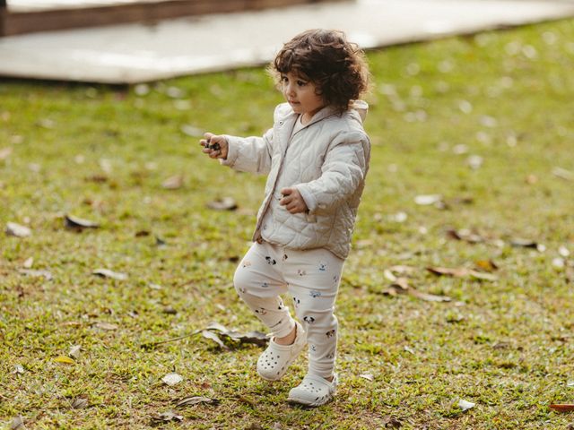 Toddler in a light jacket walking outdoors, representing kids product lines
