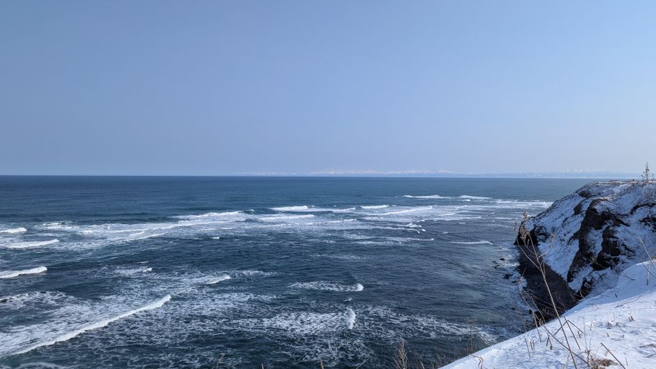Beautiful winter sea with snow-covered cliffs in Hokkaido, Japan.