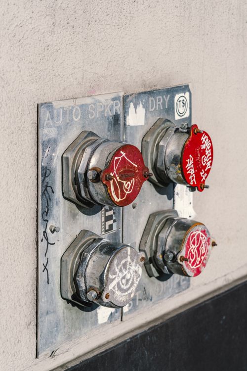 Free Close-up of painted metal sprinkler connectors with vibrant urban graffiti art. Stock Photo