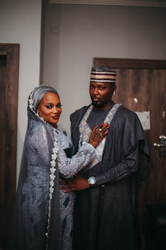 A couple poses in traditional Nigerian clothing, showcasing cultural elegance.