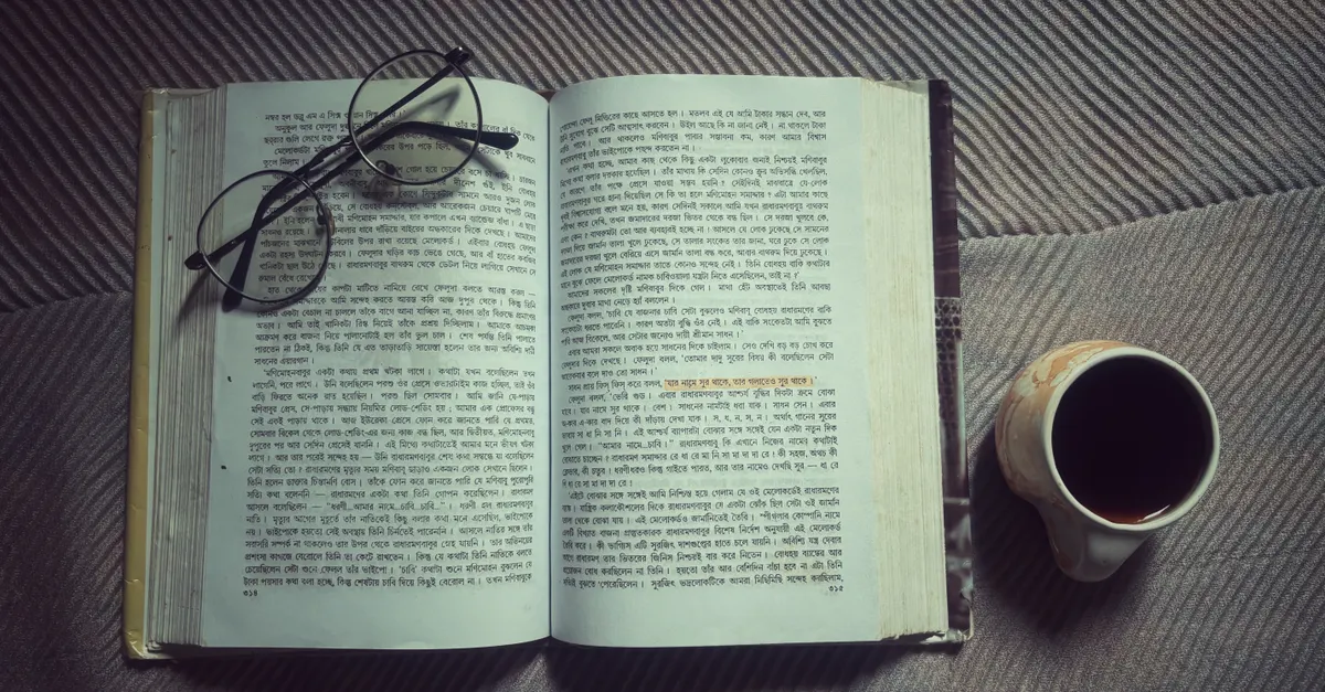 A person reading dense legal text under warm light, representing legal research in Hindi and vernacular languages