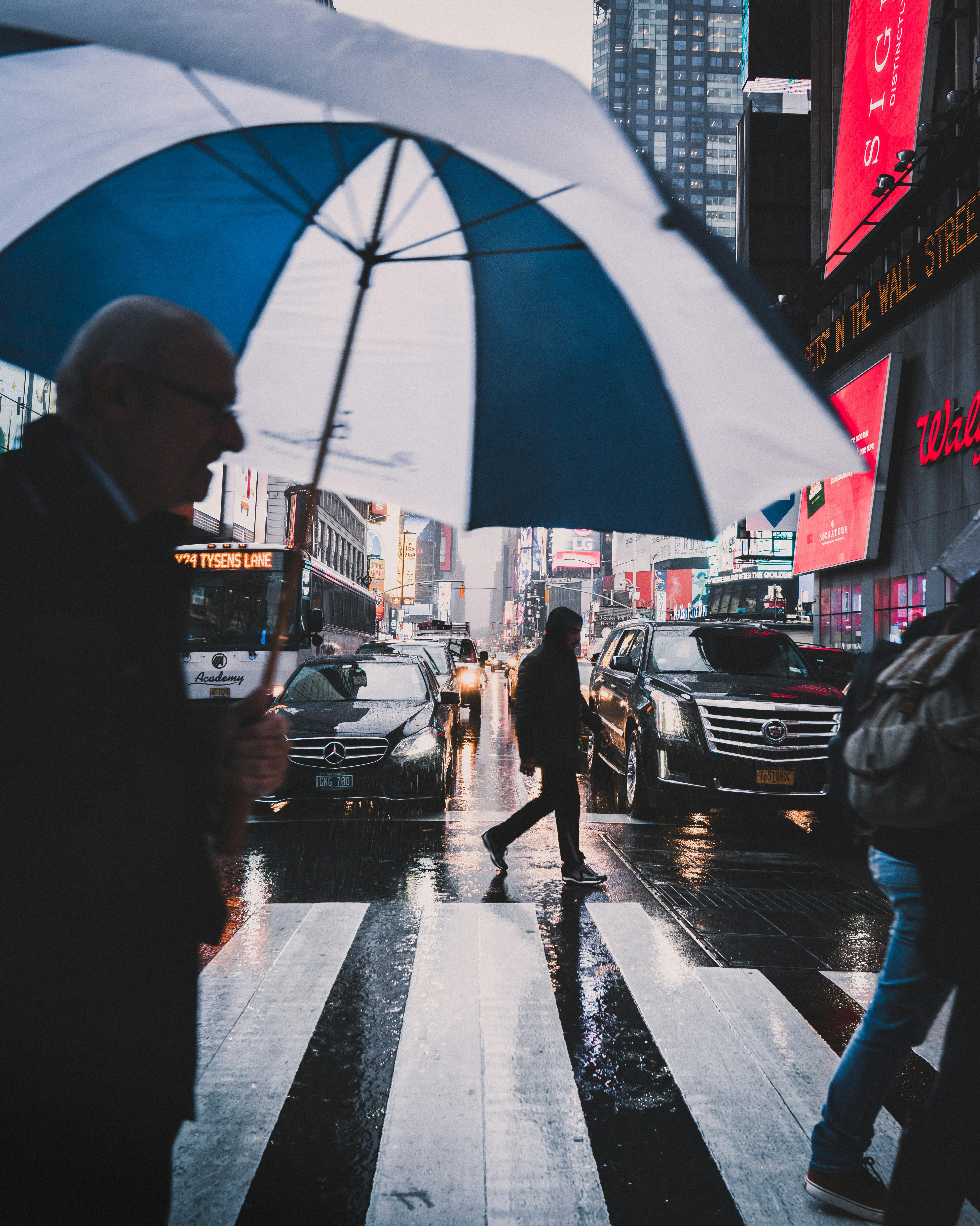 photo of man holding umbrella