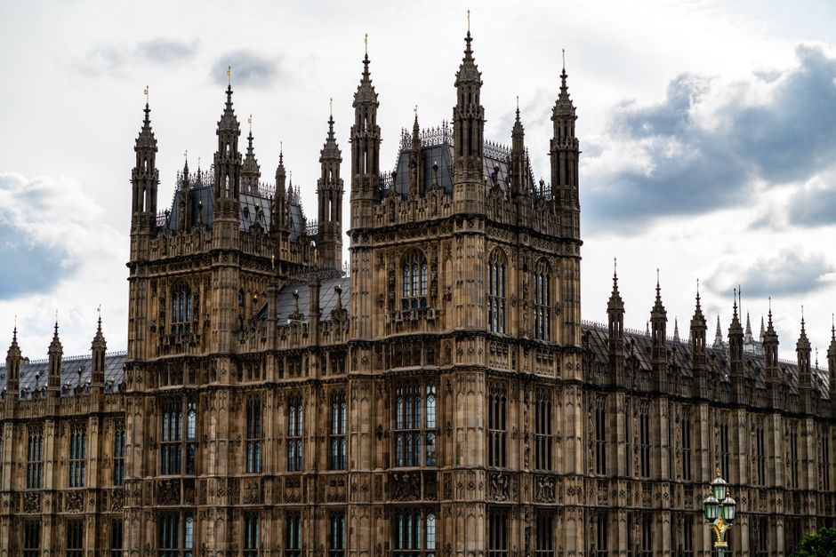 Explore the grandeur of London's iconic Gothic-style Houses of Parliament under a cloudy sky.