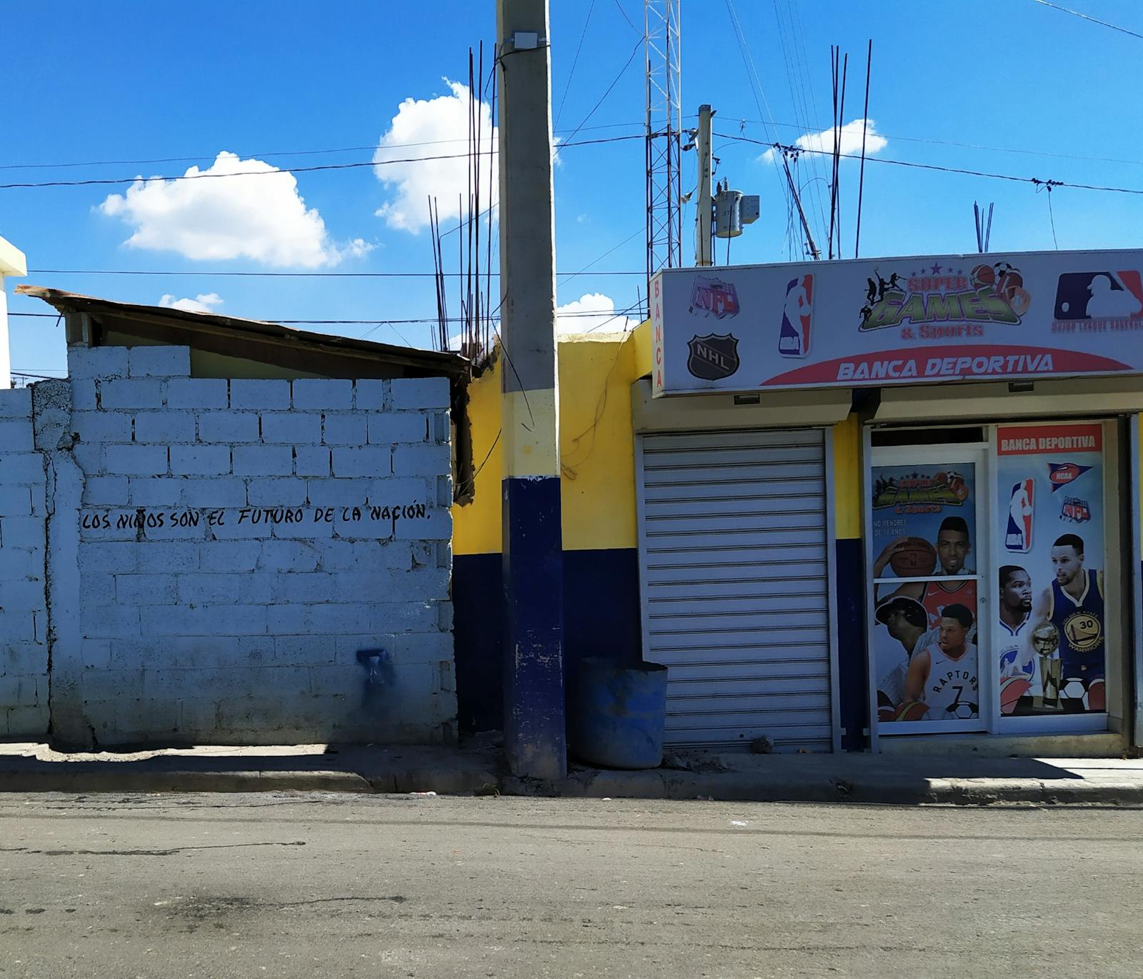 People walking near an amusement park entrance at dusk