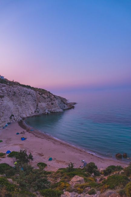 Beautiful pink sunrise over the tranquil coast of İzmir, Türkiye, with a serene beach view.
