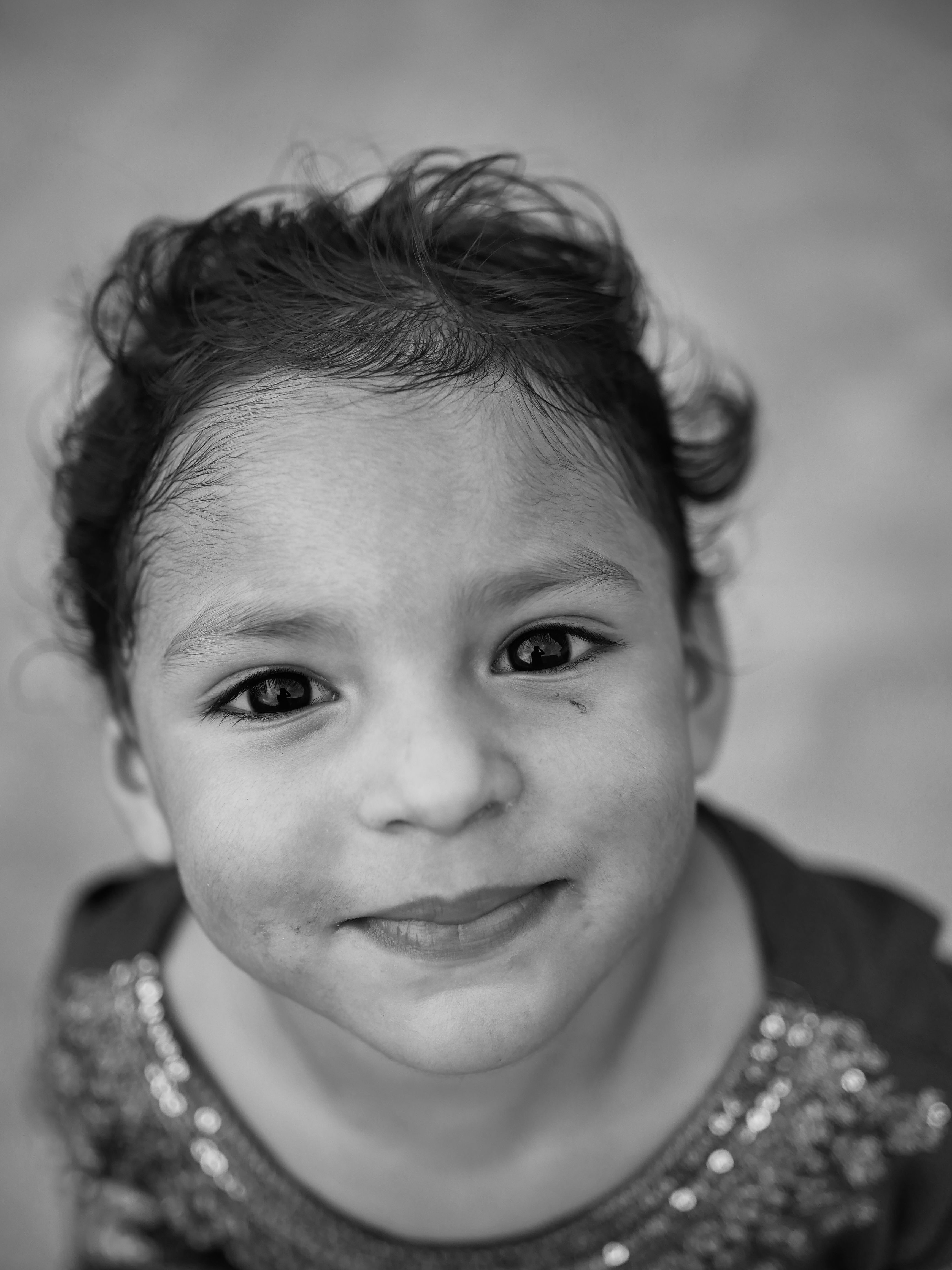 Black and White Portrait of a Smiling Child · Free Stock Photo