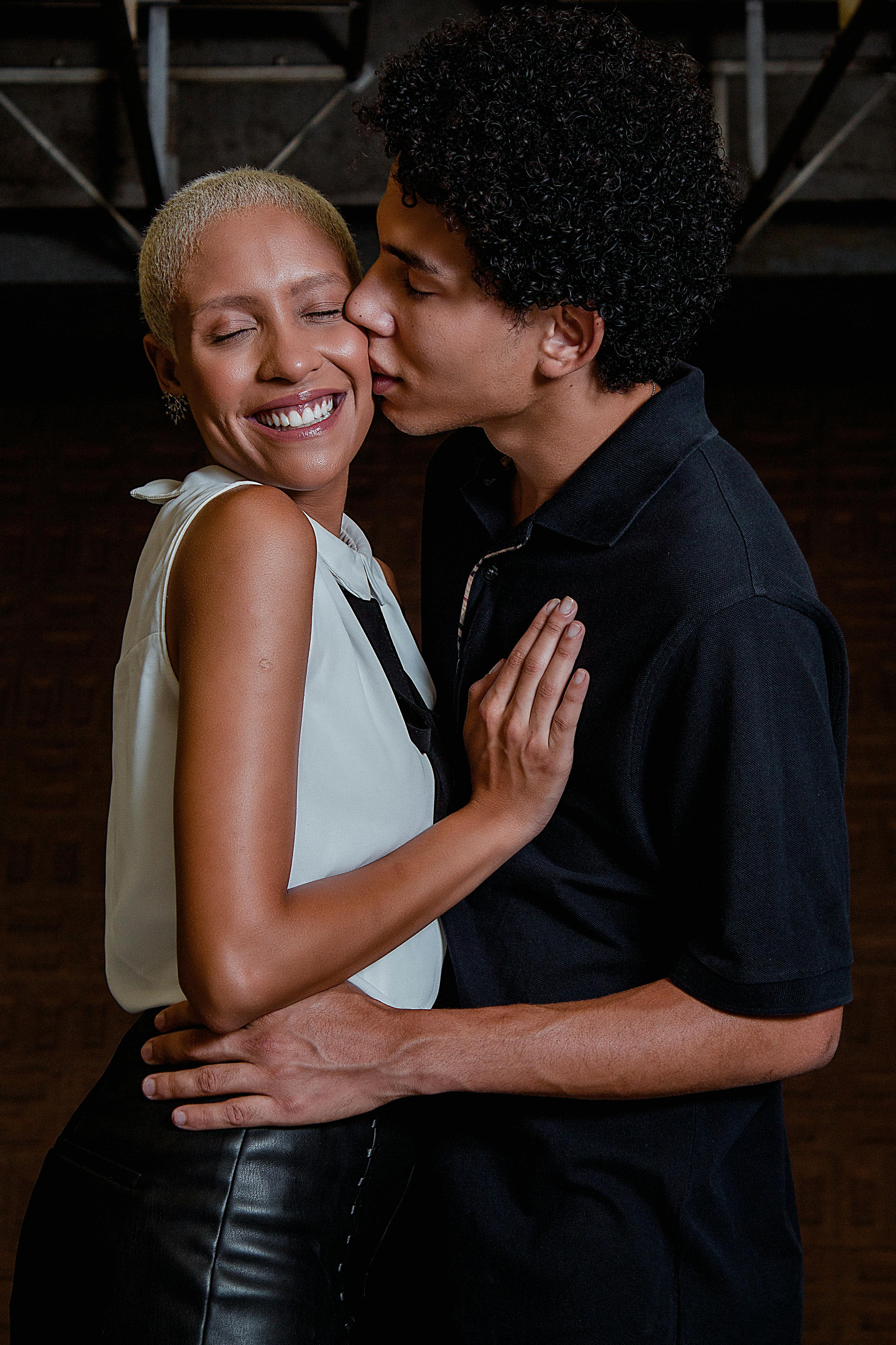 Man Kissing the Woman Wearing White Dress