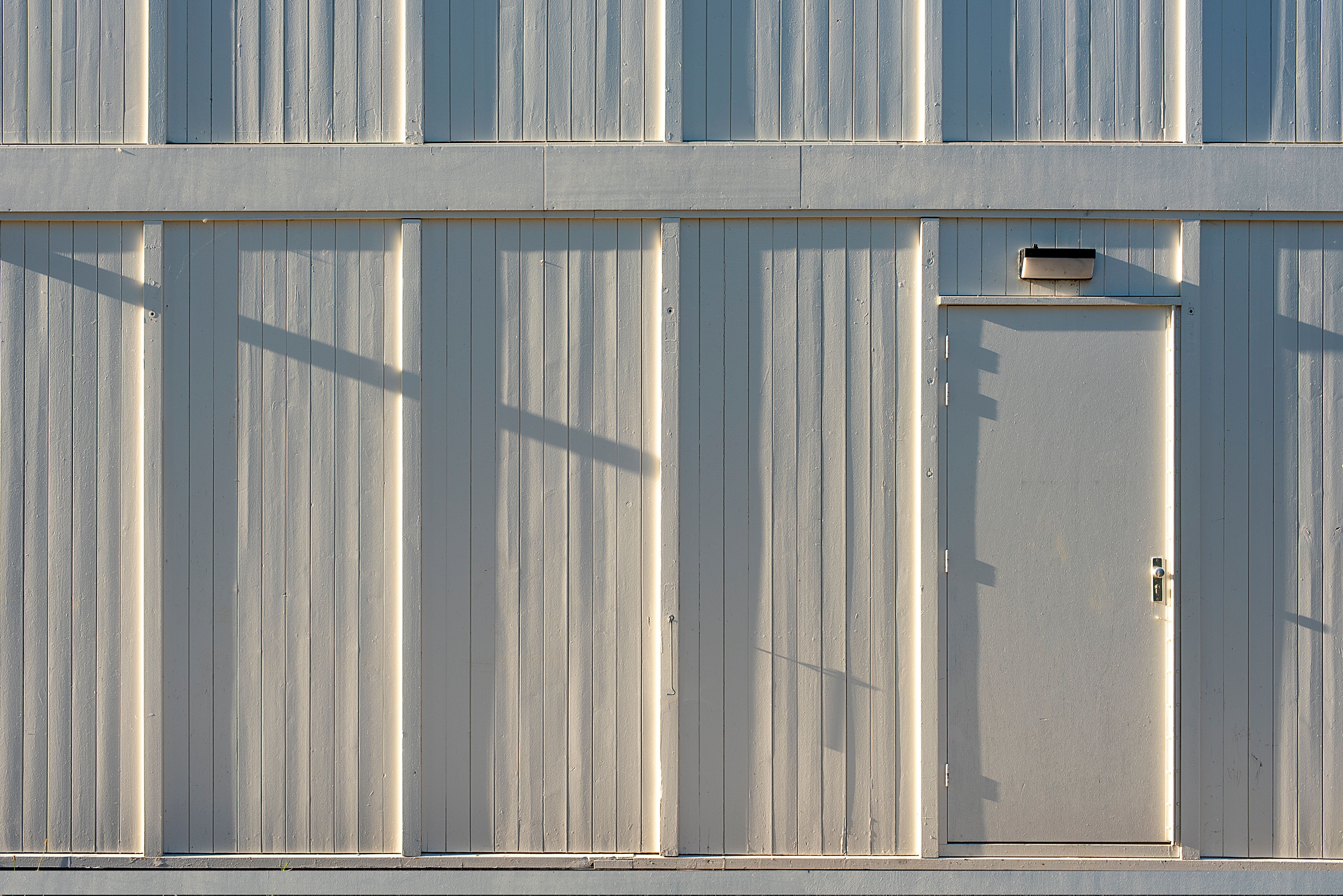Minimalist Industrial Wall with Door and Shadows · Free Stock Photo