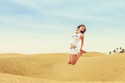 Free Full Length of a Woman Standing in a Desert Stock Photo