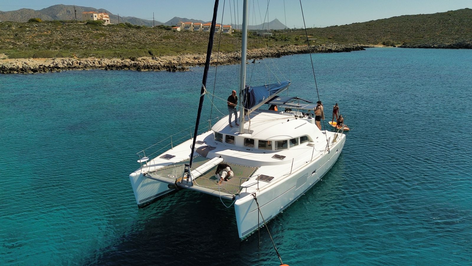 Aerial view of a luxury catamaran anchored in clear turquoise water