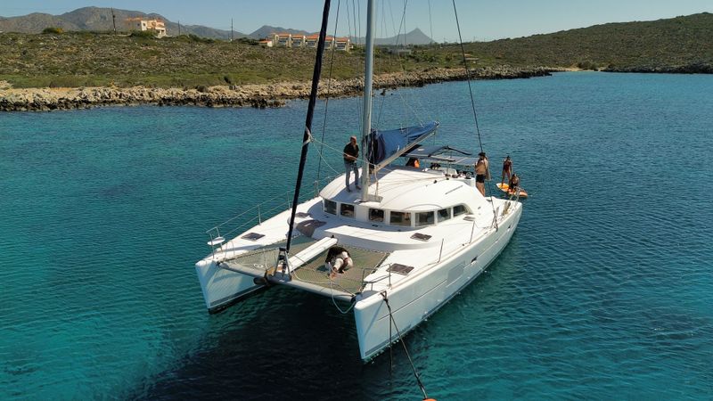 Aerial view of a luxury catamaran anchored in clear turquoise water