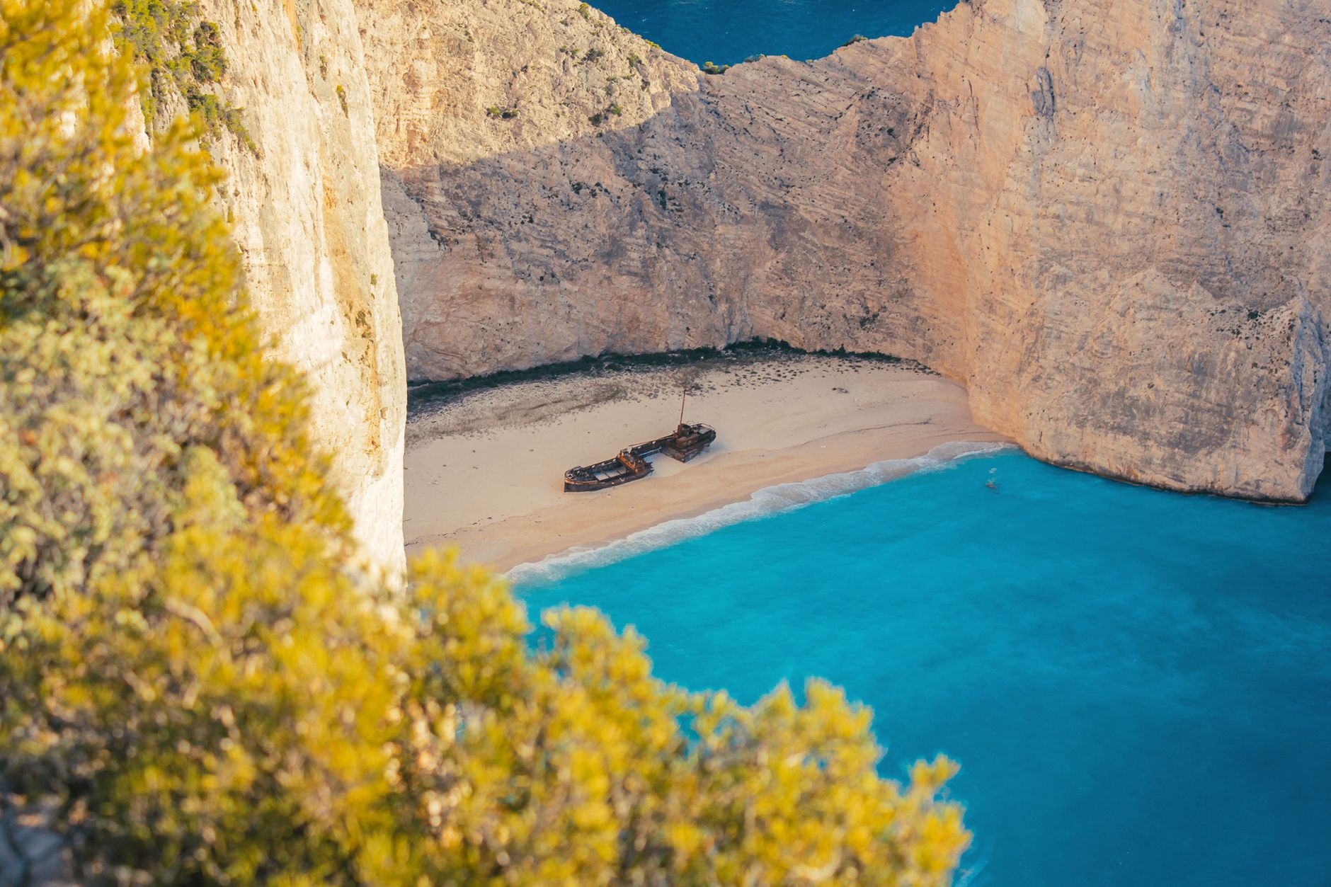 White chalk cliffs above a dark-sand cove at Governor's Beach on the south coast of Cyprus