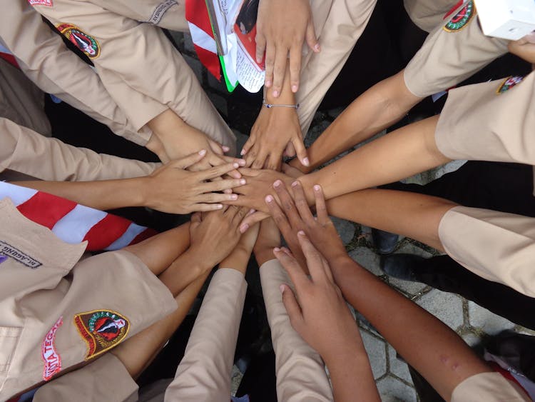 Crop Military Ethnic Females Stacking Hands