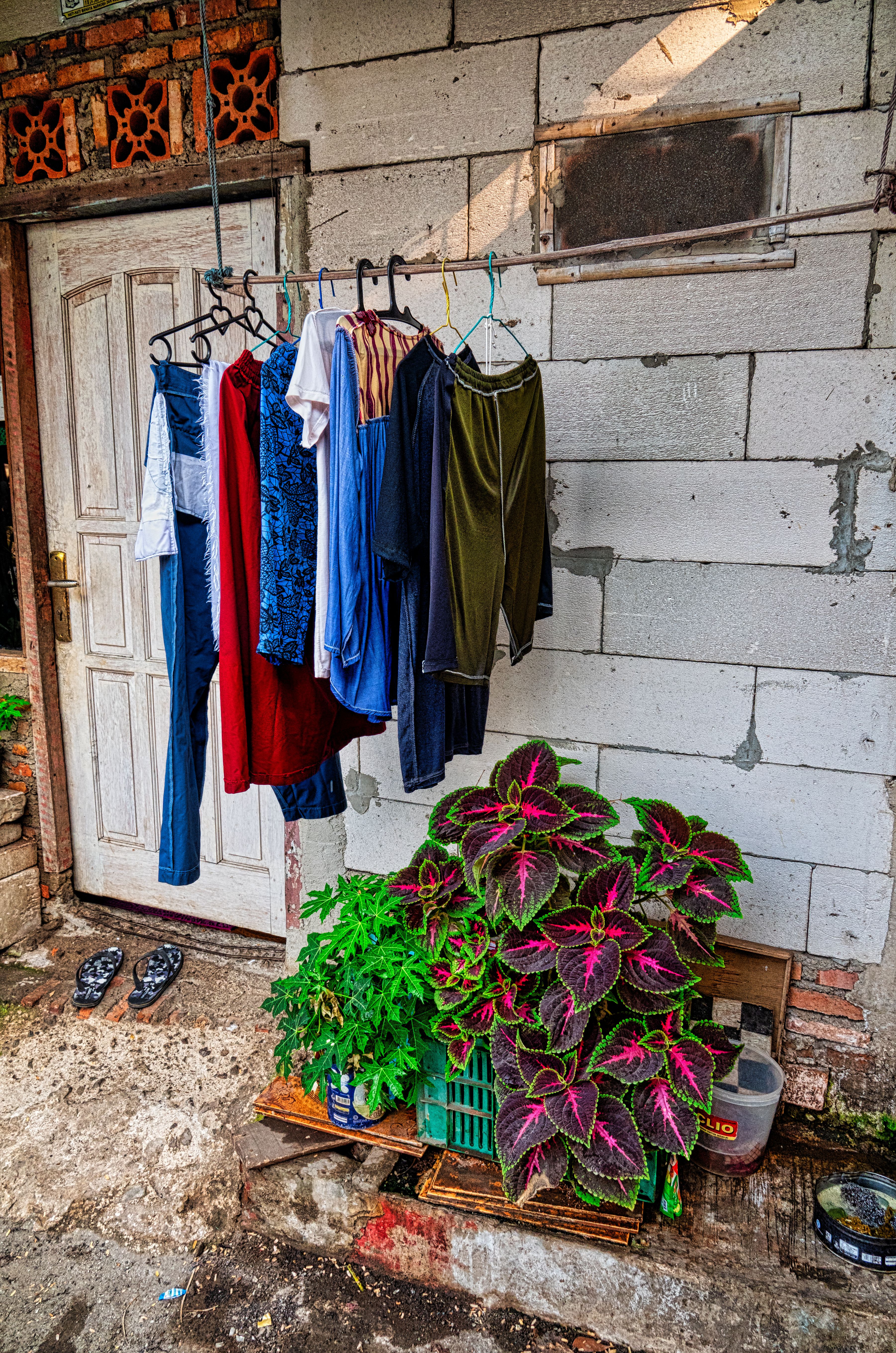 assorted-color-clothes-in-hanger-on-rod-near-wall-free-stock-photo