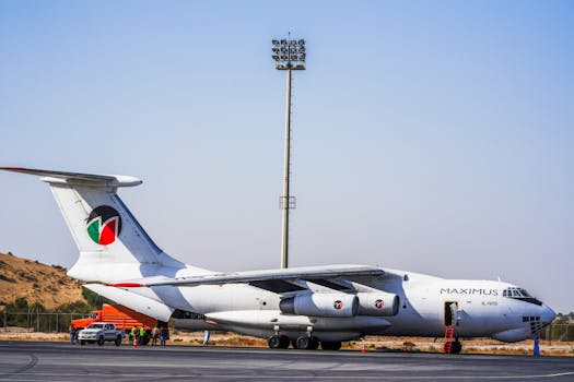Maximus aircraft on tarmac in Sindh, Pakistan, with clear blue sky.
