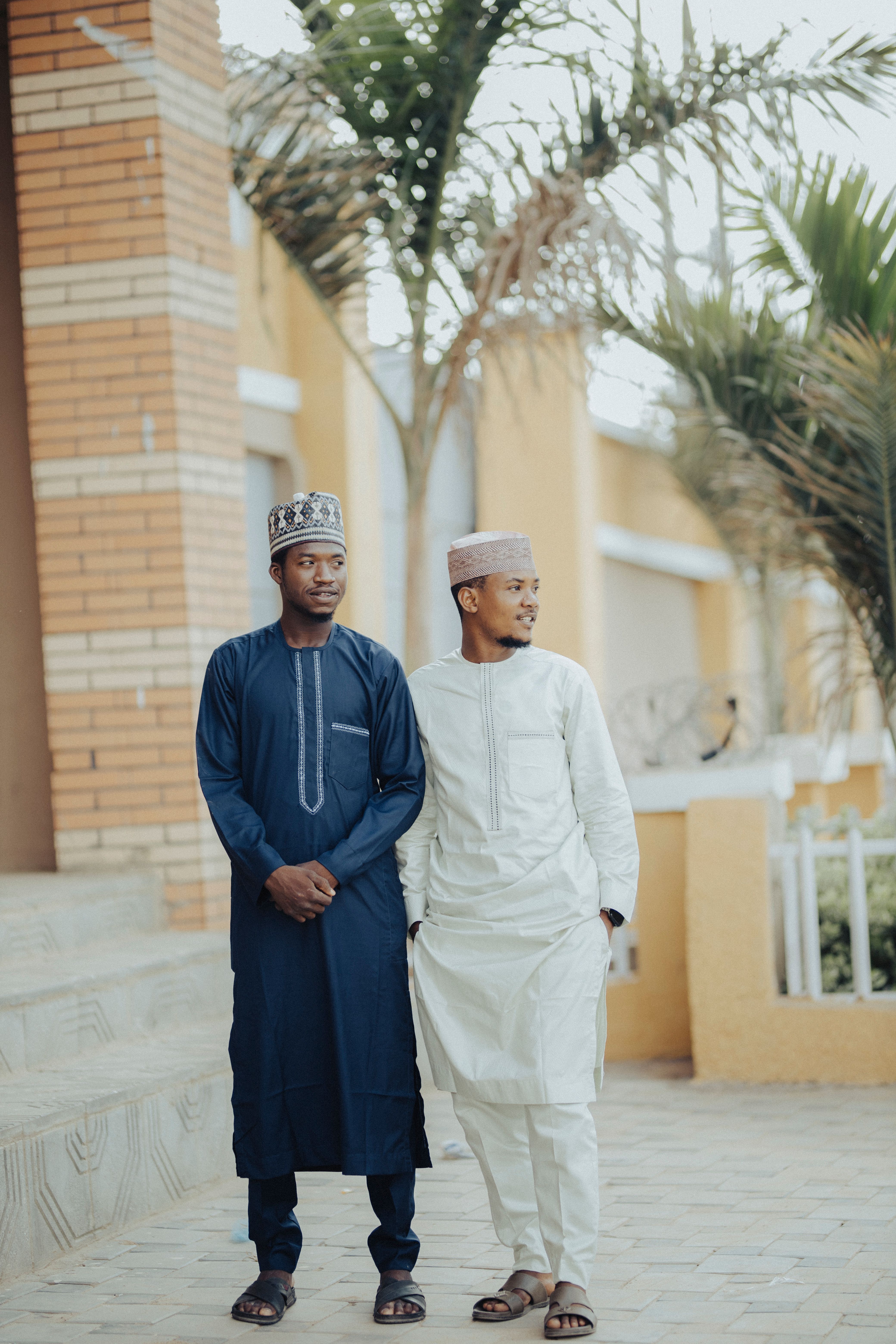 Two Men in Traditional Attire Walking Outdoors · Free Stock Photo