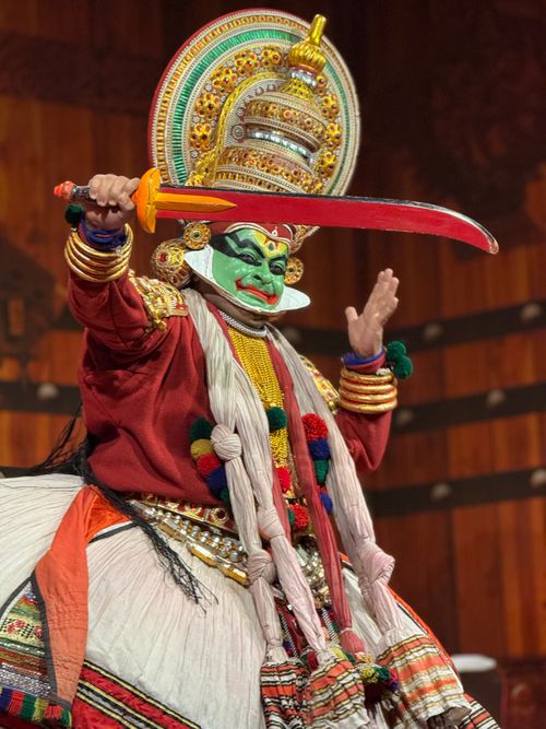 Free A Kathakali artist in vivid costume performing a traditional dance on stage. Stock Photo