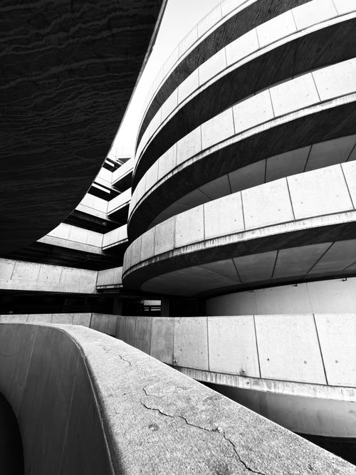 Free A striking black and white image of modern architectural curves in an urban setting. Stock Photo