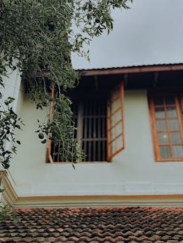 A rustic house in Ernakulam, India, showcasing traditional architecture with lush greenery.