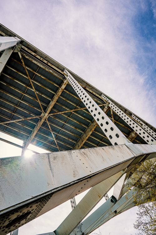 Free Low angle view of a metal bridge structure against a blue sky in Portland, Oregon. Stock Photo
