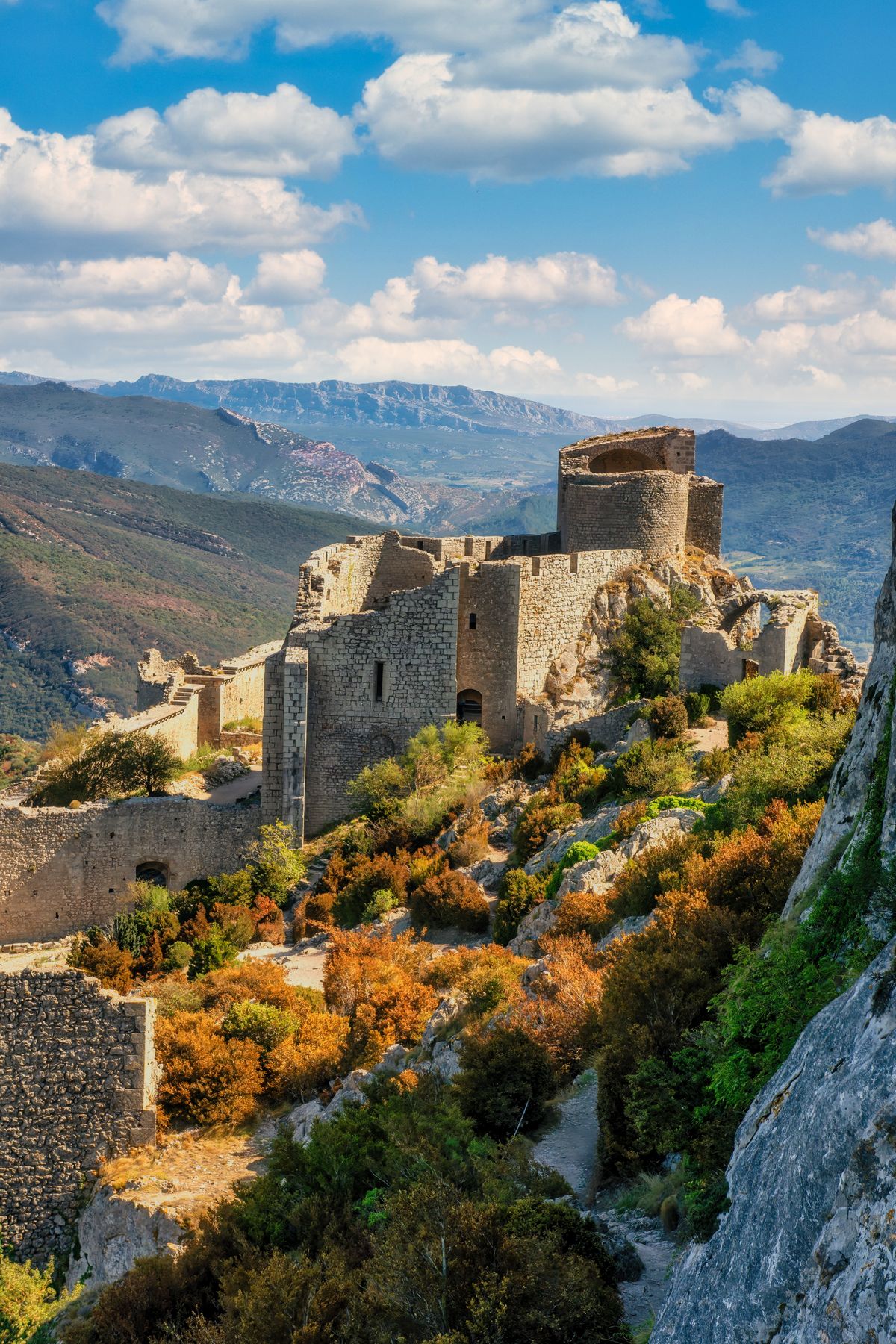 The Cathar castle of Peyrepertuse in ruins along a mountain ridge