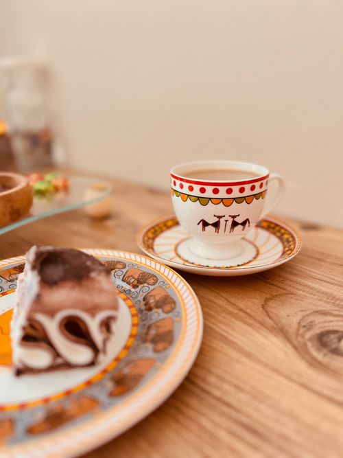 Free Elegant Turkish tea cup and dessert on intricately decorated plates, Ankara, Türkiye. Stock Photo