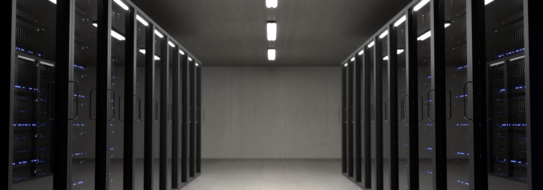 An aisle between rows of server racks.