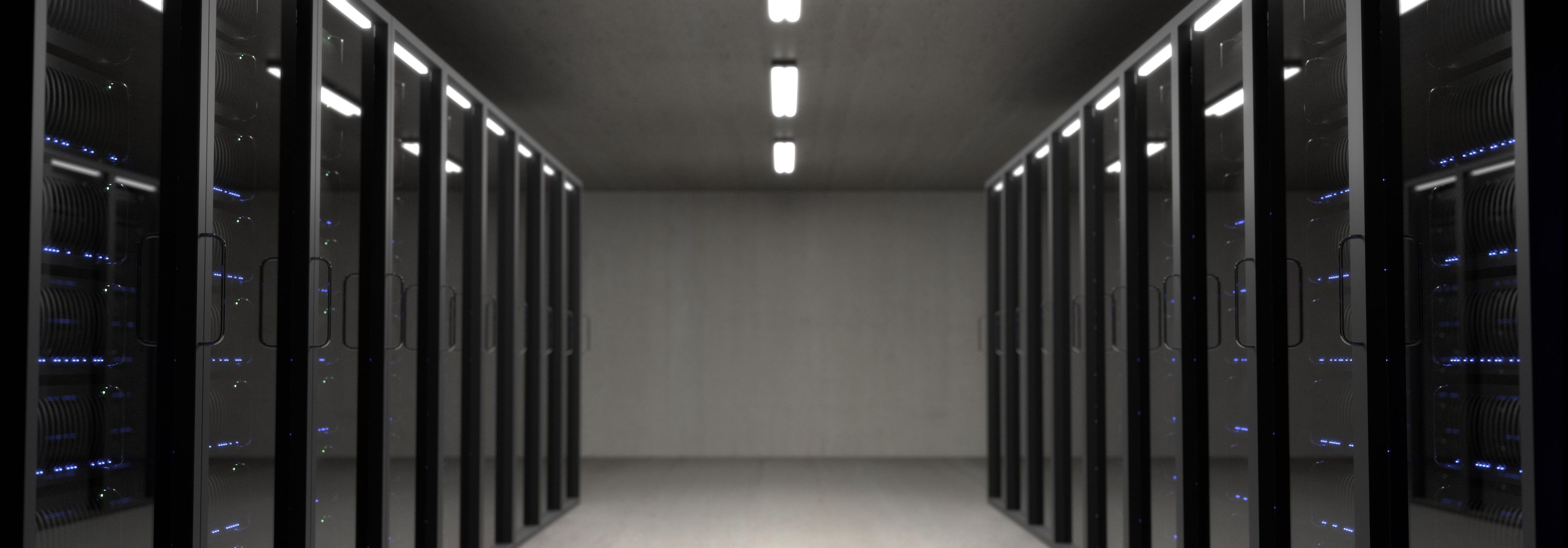 Server racks cabled in a dark data centre