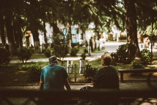 A senior couple enjoys a peaceful afternoon in a lush green park in Kutaisi, Georgia.
