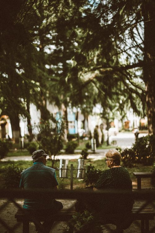 Free Elderly couple enjoying a peaceful afternoon in a lush park in Kutaisi, Georgia. Stock Photo