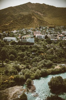 Explore the picturesque landscapes of Kutaisi, Georgia, featuring lush greenery and the Rioni River.