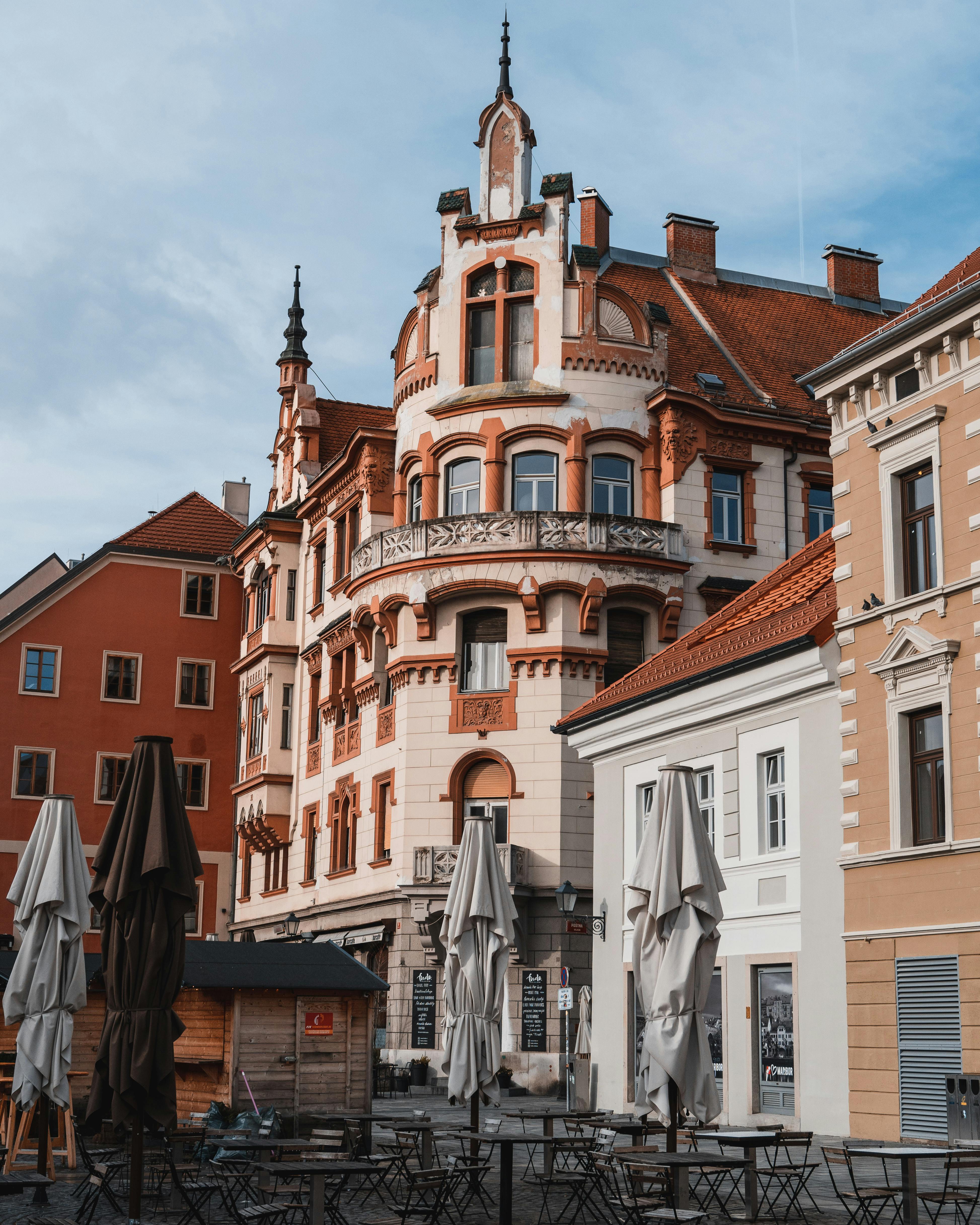 Charming European street view with historic architecture and outdoor cafe.