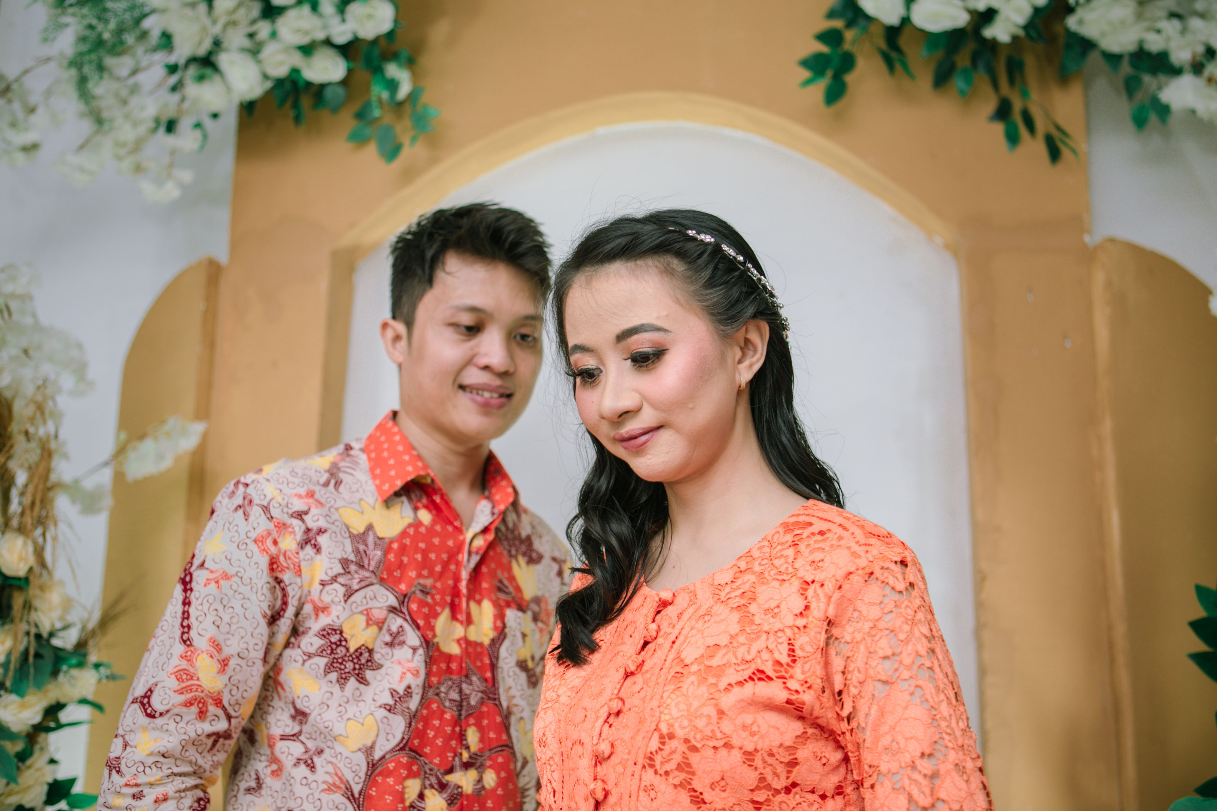 Traditional Couple in Floral Attire at a Celebration