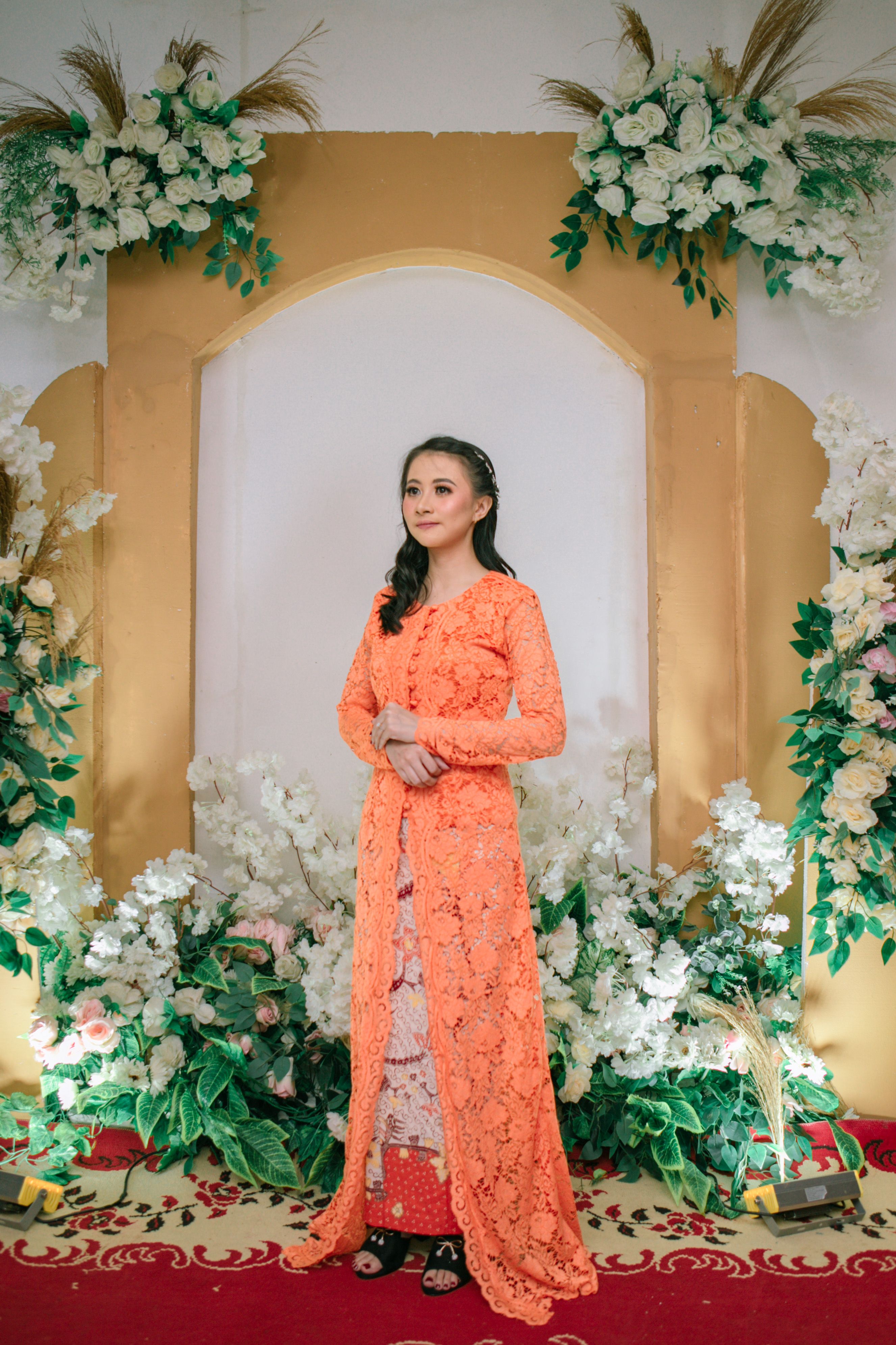Elegant Woman in Traditional Dress at Floral Ceremony · Free Stock Photo