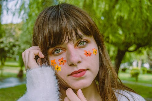 Selective Focus Photography of Woman With Flower Face Paint