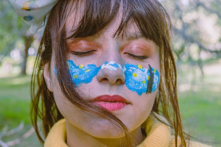 Teen Girl With Colorful Painting On Face