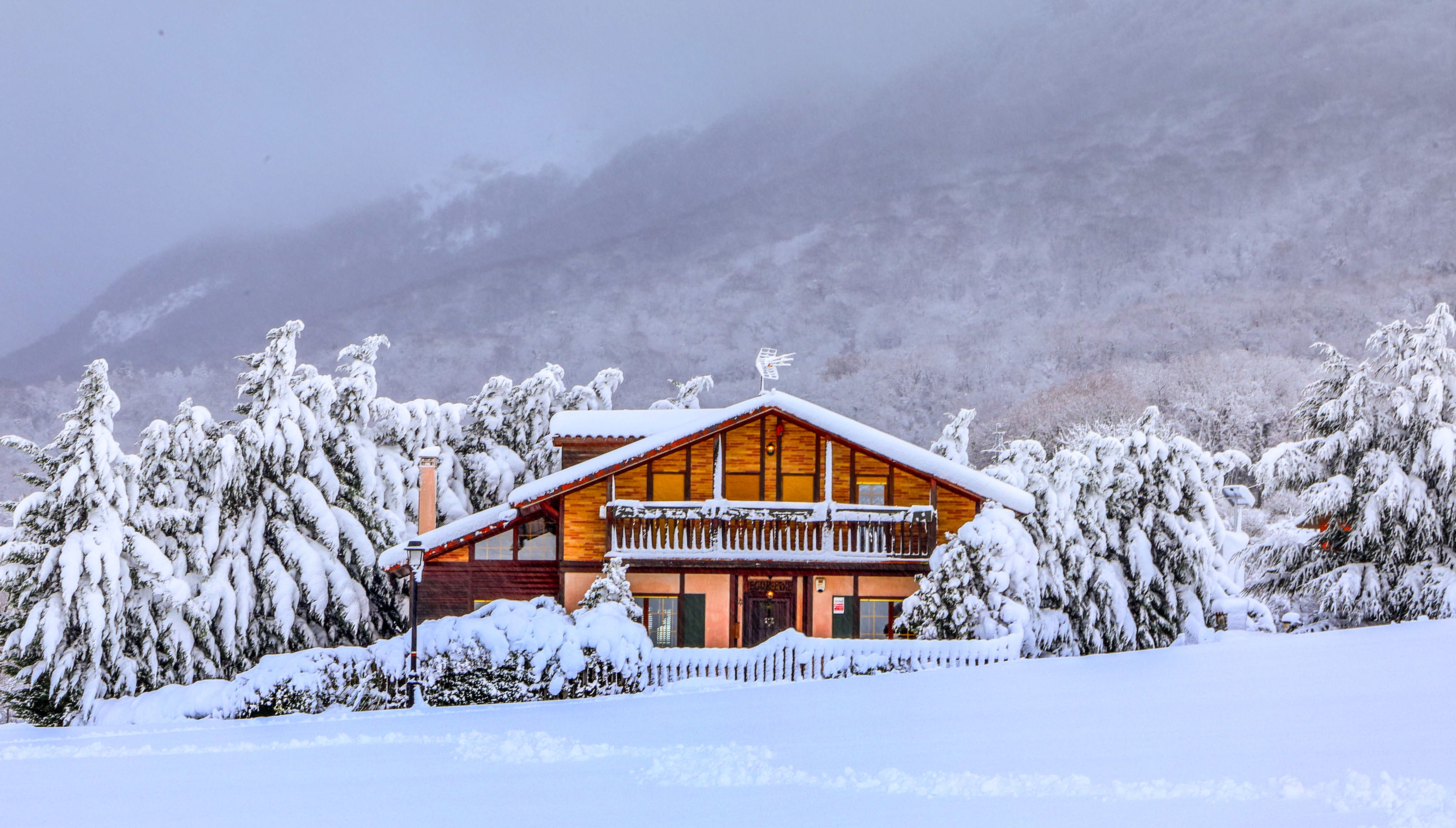 Cozy Wooden Cabin in Snowy Winter Wonderland · Free Stock Photo