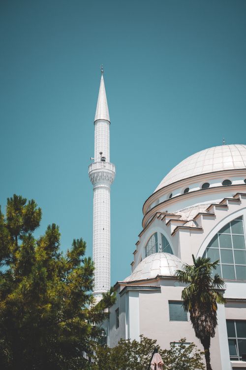 Free Scenic view of a mosque minaret in Shkodër, Albania under a clear blue sky. Stock Photo