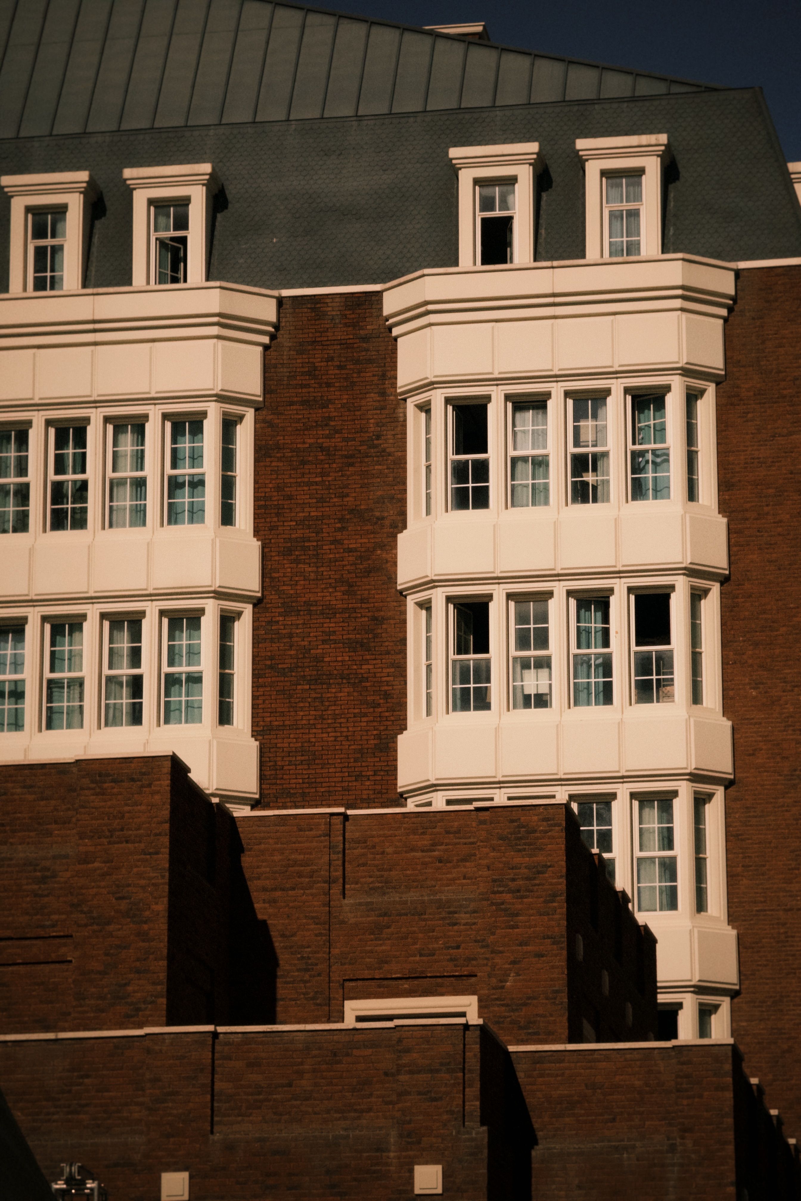 Brick building exterior showcasing detailed architectural facade with windows.