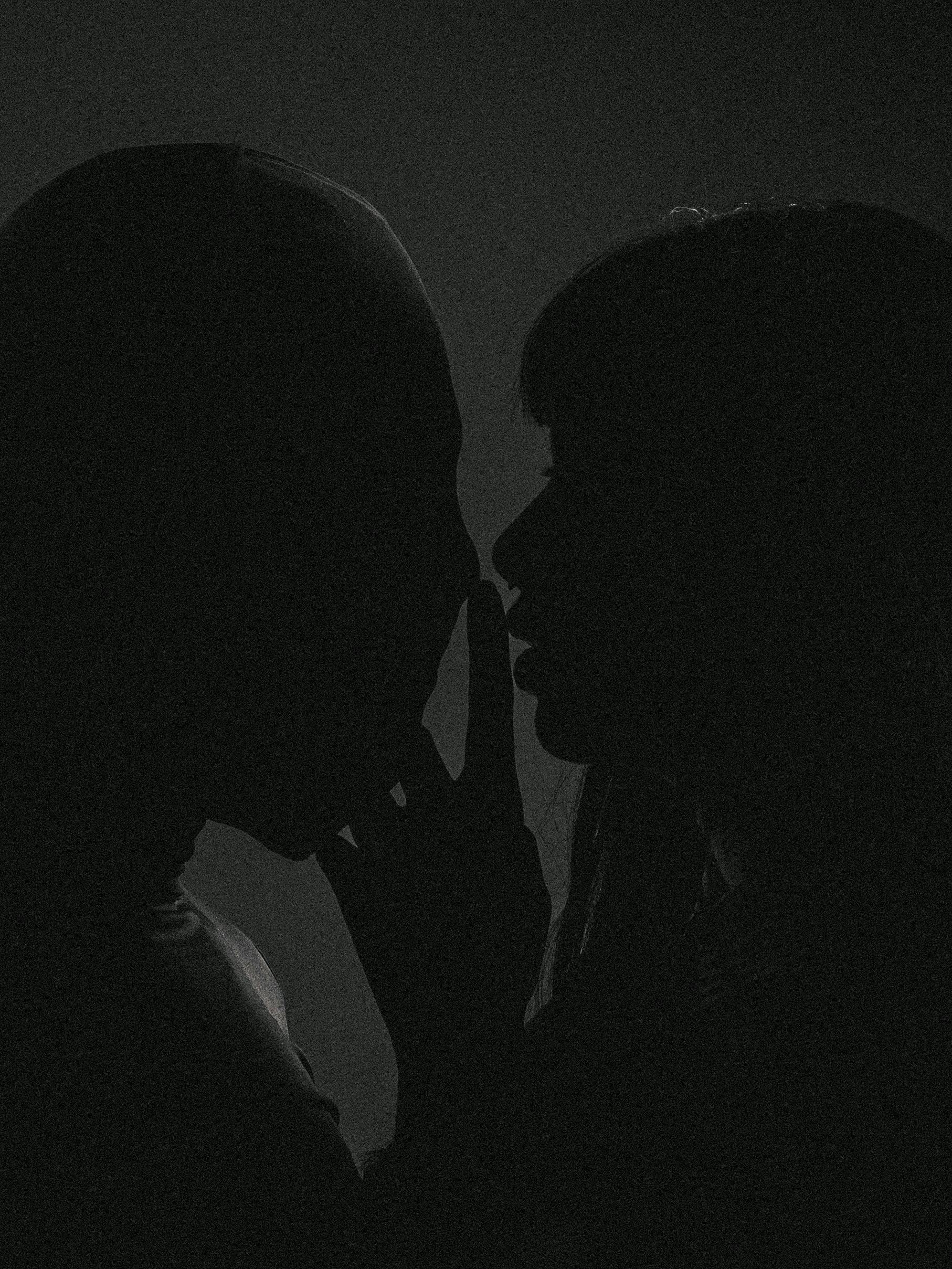 Silhouette intimate moment in low light, artistic curves evoking trance-like sensual surrender and midnight surrender erotic fantasy