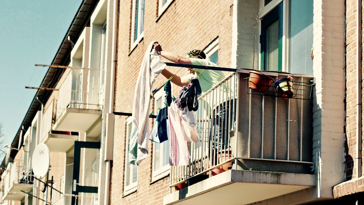 Free Low Angle View of Clothes Hanging on Balcony Stock Photo