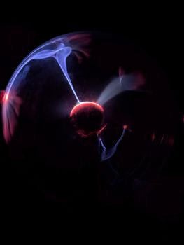 A visually captivating plasma globe emitting vibrant neon glows against a dark background.