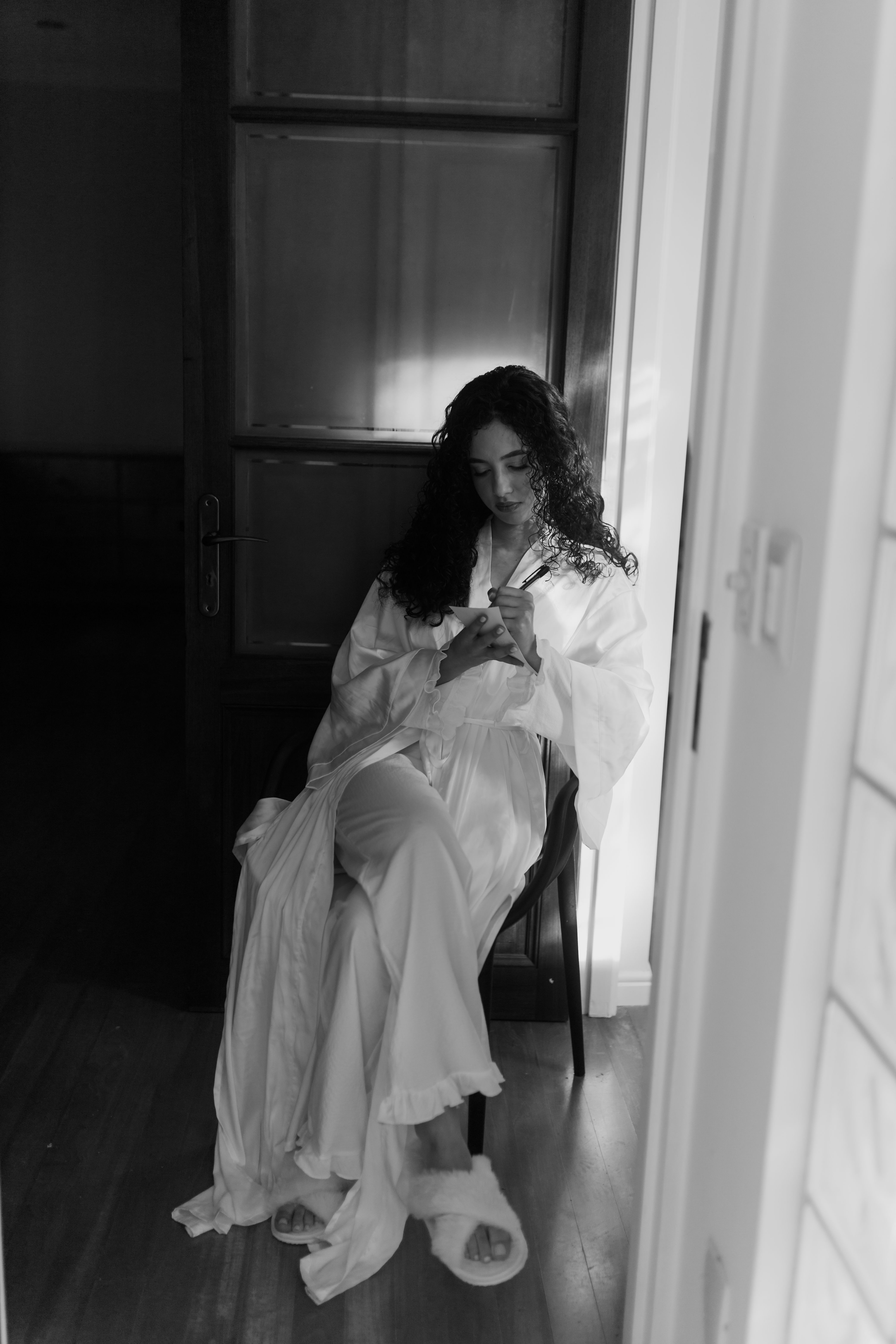 An elegant woman relaxing indoors in black and white
