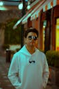 Man in White Hoodie with Sunglasses at Night