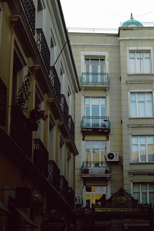 Free A narrow street view highlighting classic European urban architecture at twilight. Stock Photo