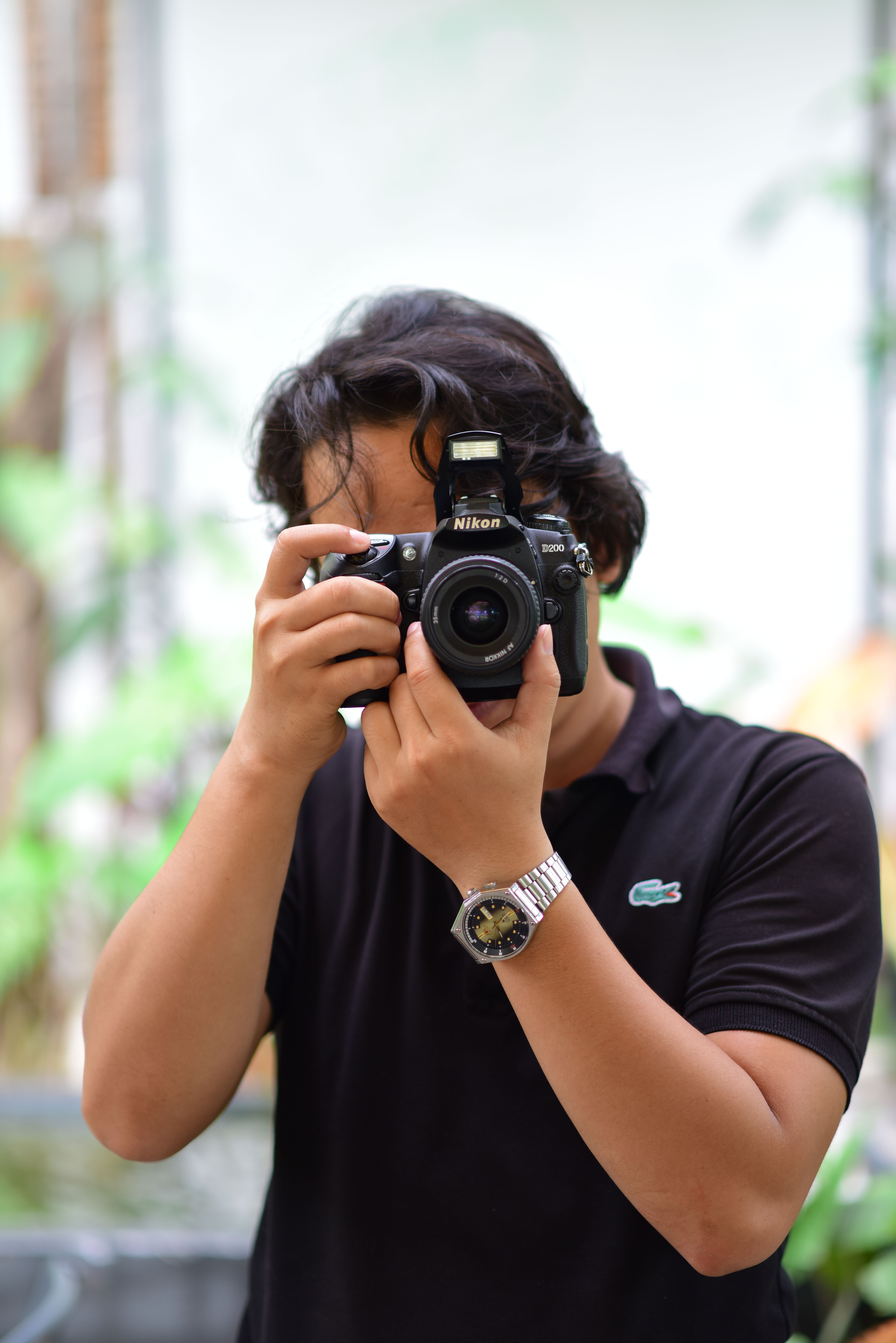 Portrait of a photographer with a DSLR camera in action, focusing creativity.